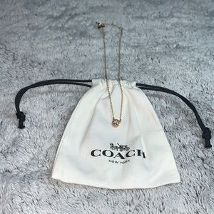Gold colored Coach necklace with gem and dust bag